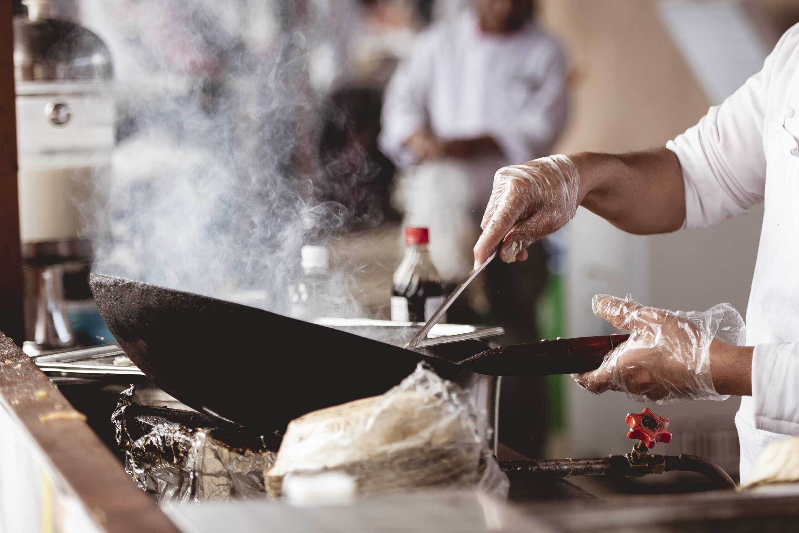 Man and Woman Wearing Black and White Striped Aprons Cooking